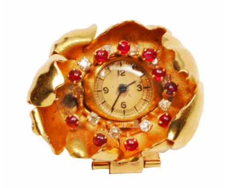 A BROOCH of stylised floral form with ruby and diamond decoration and fitted with a timepiece