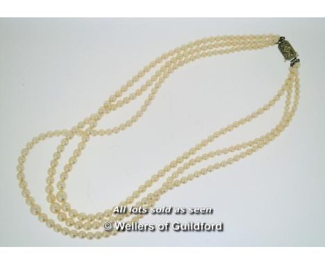 *Vintage three row pearl necklace with white metal clasp stamped 9ct, set with a small rose cut diamond, boxed (Lot subject t