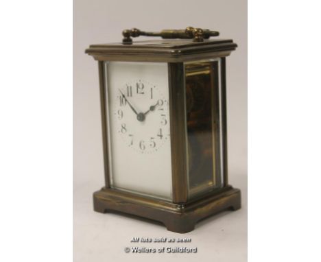A French brass carriage clock with white enamel dial and Arabic numerals, 14cm including handle.