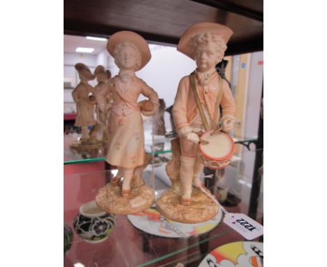 A Pair of Royal Worcester Porcelain Figures, in the Kate Greenway style, in blush ivory glaze, decorated with flowers, boy wi