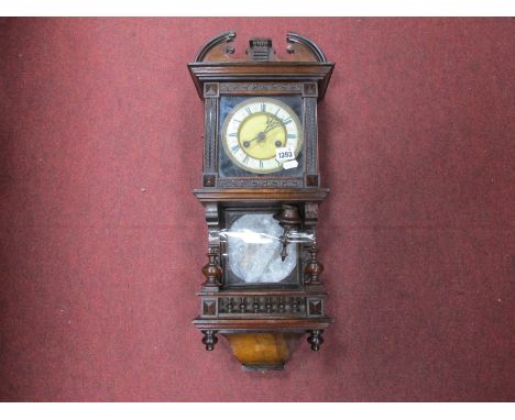 An Early XX Century Wall Clock, in walnut casing the dial featuring cross arrows trade mark, approximately 60cm high.