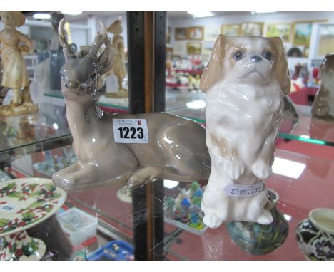 A Royal Copenhagen Model of A Stag, No 756 (1975-1979); together with a Royal Copenhagen Pekingese, No 1776 (1969-1974). (2)
