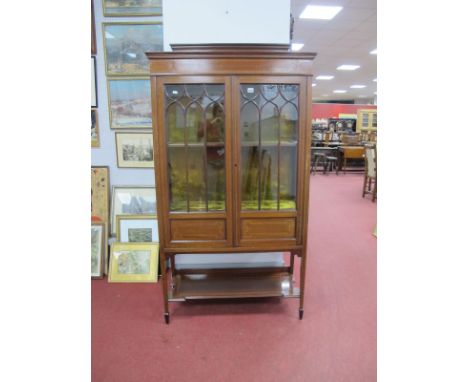 An Edwardian Mahogany Inlaid Display Cabinet, with a applied pediment, twin astragel doors, two internal shelves on tapering 