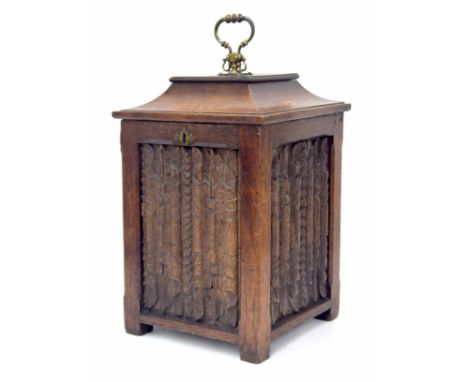 Antique oak fireside coal bucket, the hinged caddy top cover closing a metal liner over four carved linen fold panels, 11" wi