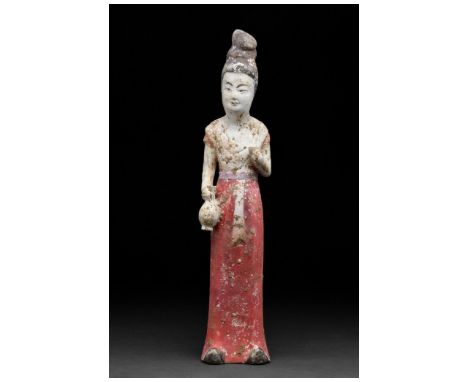 Ca. 618-907. Tang Dynasty. A finely modelled terracotta figure of a female court lady. She is depicted standing and attentive