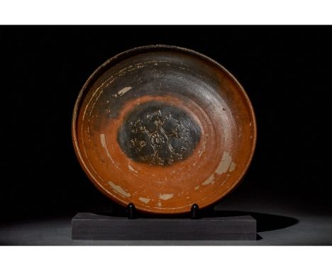 Ca. 350-300 BC. Hellenistic/Magna Graecia. An intact ancient Greek bowl with traces of black glaze. The tondo is decorated wi
