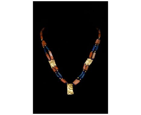 Ca. 100-300 AD. Roman. A beautiful necklace made of two strings of carnelian and blue glass rectangular and flat beads with g