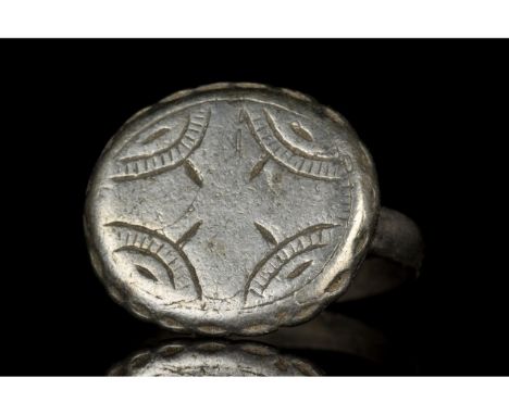 Ca. 1200-1300 AD. Crusaders period. A medieval silver ring with a thin circular band and an applied oval bezel decorated with