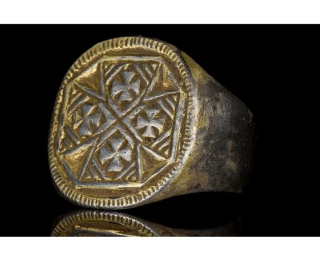 Ca. 1100-1400 AD. Crusaders Period. A stunning gilded silver ring with a circular band and flared shoulders. The bezel is dec