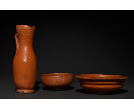 Ca. 300-400 AD. Late Roman. A collection of three terra sigillata vessels including one ring-footed bowl, one tall ring-foote