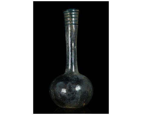 Ca. 100-300 AD. Roman. A beautiful colourless with green tinge glass flask with a spherical body, a long, flaring cylindrical