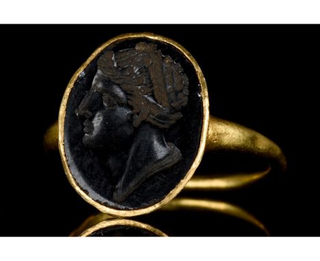 Ca. 200 BC-100 AD. Late Hellenistic/ Early Roman. A beautiful gold ring with a thin circular band and applied oval bezel set 