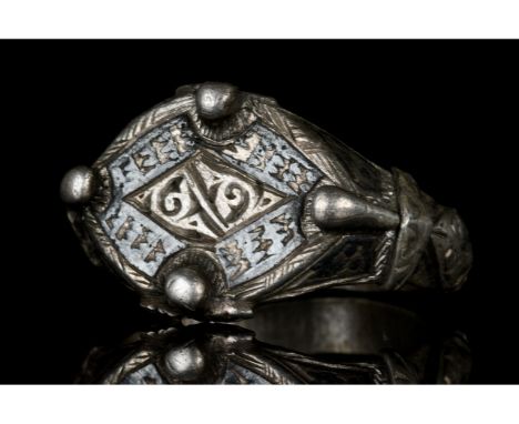 Ca. 1000-1200 AD. Eastern Viking. A silver ring with a lozenge-shaped bezel engraved with runic symbols and niello decoration