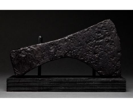 Ca. 1000-1200 AD. Viking Age. An iron axe head with a curved blade, triangular cheek, and elliptical shaft-hole. The profile 