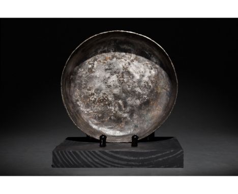 Ca. 100-300 AD. Roman. A beautifully preserved, hammered silver vessel with a plain rim and an interior surface decorated wit