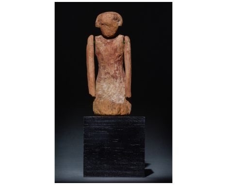 Ca. 2055 -1650 BC. Middle Kingdom. An articulated wooden tomb figure. The statuette's surface contains traces of white at the