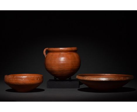 Ca. 300-400 AD. Late Roman. A collection of three terra sigillata vessels including one ring-footed bowl, one bulbous jug wit