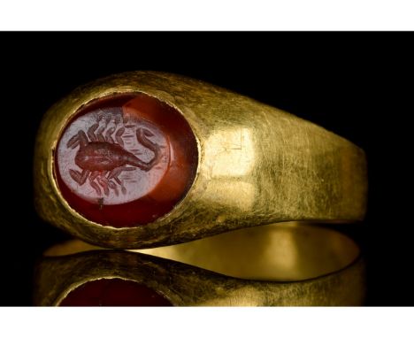 Ca. 100-300 AD. A gold ring with a circular band, flared shoulders, and an oval bezel set with a carnelian gem; the delicate 