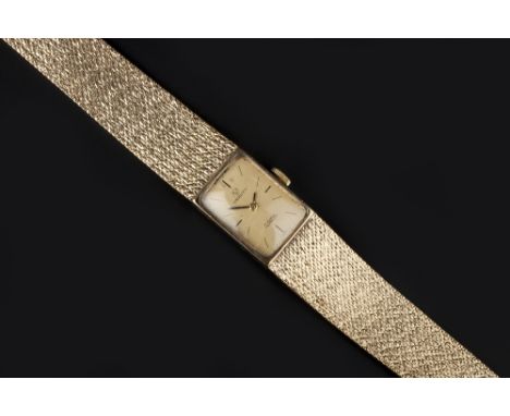 A LADY'S 9CT GOLD BRACELET WATCH, the rectangular gilt dial with baton markers, signed Verity, to a jewelled manual movement,