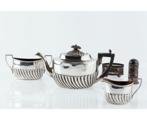 A LATE VICTORIAN SILVER THREE PIECE BACHELOR'S TEA SET, of half lobed design, the teapot with ebonised handle and knop by Har