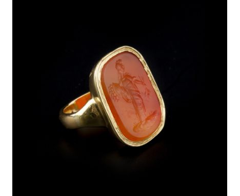 A CORNELIAN INTAGLIO RING, the 19th century cushion-shaped intaglio incised to depict a classical female figure holding a cor