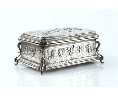 A LATE 19TH CENTURY CONTINENTAL SILVER CASKET, repoussé decorated with scenes of peasants merrymaking, on figural and scroll 