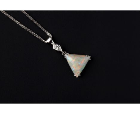 AN OPAL AND DIAMOND PENDANT ON CHAIN, the triangular cabochon opal in double claw setting, surmounted by a pear-shaped diamon