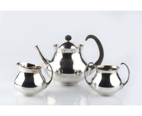 A SILVER THREE PIECE TEA SERVICE by Eric Clements, for Mappin & Webb, of plain, slightly baluster design, the teapot with com