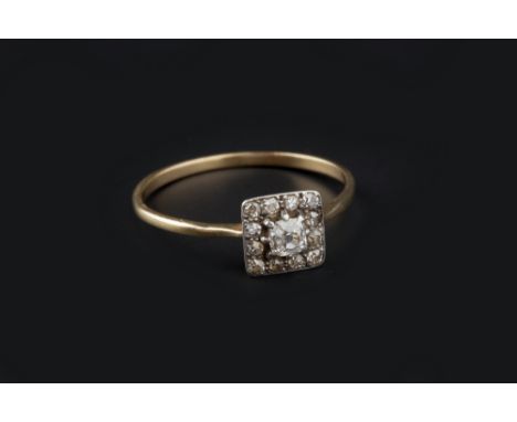 A DIAMOND CLUSTER RING, the principal cushion-shaped old-cut diamond claw set within a square border of single-cut diamonds, 