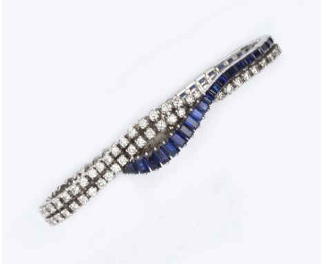 A LADY'S SAPPHIRE AND DIAMOND SET BRACELET WATCH BY AUDEMARS PIGUET, designed as two articulated lines of graduated round bri