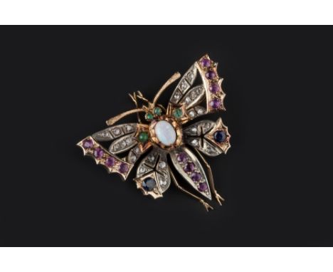 A VARI GEM-SET BUTTERFLY BROOCH, the openwork outstretched wings of lasque-cut diamonds edged with circular mixed-cut rubies 