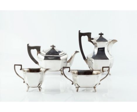 A SILVER FOUR PIECE TEA SERVICE, of elongated octagonal section with ebonised handles and knops, comprising teapot, hot water