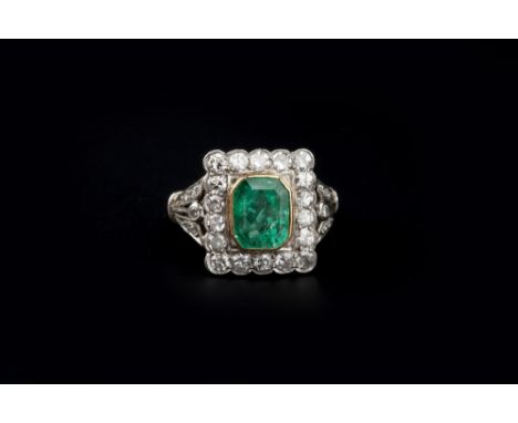 AN EMERALD AND DIAMOND PANEL RING,  the octagonal step-cut emerald collet set within a rectangular border of Swiss and single