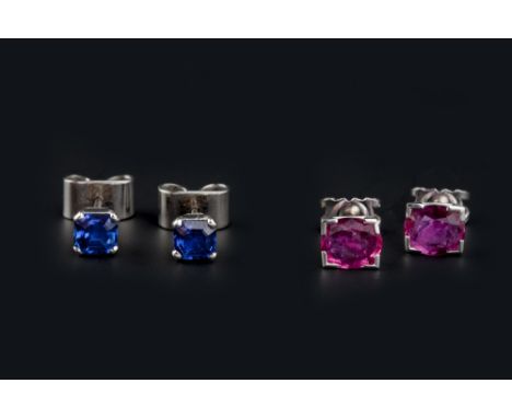 TWO PAIRS OF GEM SET EAR STUDS, comprising a pair of sapphire single stone ear studs, each octagonal step-cut sapphire in fou