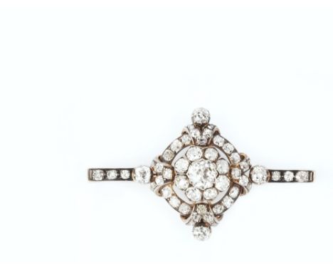 A DIAMOND PANEL BROOCH, centred with a cluster of graduated cushion-shaped old-cut diamonds, to an openwork hoop-shaped surro