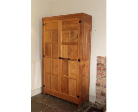 Workshop of Robert Mouseman Thompson (Kilburn): A Bespoke English Oak Panelled Linen Cupboard, penny moulded top above two do