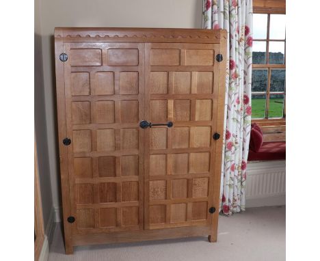 Workshop of Robert Mouseman Thompson (Kilburn): An English Oak Panelled Wardrobe, with half penny moulding above two doors, w