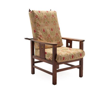 An Arts &amp; Crafts Oak Reclining Lounge Chair, shaped arms above a slatted side with pierced heart motif, hinged slatted ba