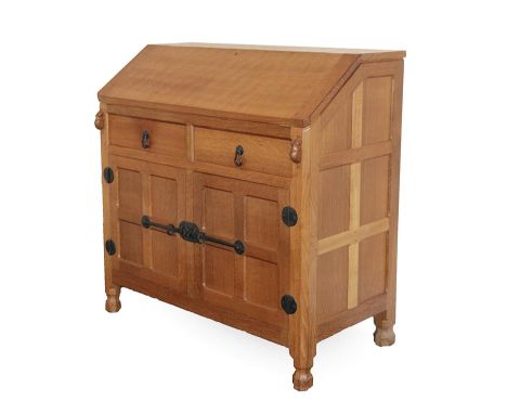 Workshop of Robert Mouseman Thompson (Kilburn): An English Oak Bureau, post 1960's, with fall front top resting on two lopers