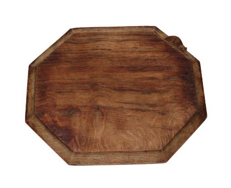 Workshop of Robert Mouseman Thompson (Kilburn): An English Oak Bread Board of canted rectangular shape, with carved mouse tra