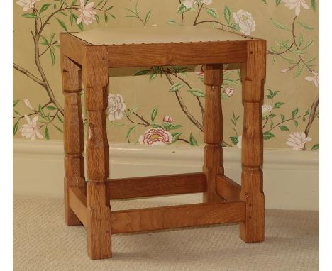 Workshop of Robert Mouseman Thompson (Kilburn): An English Oak Dressing Table Stool, with upholstered cow hide seat, on four 