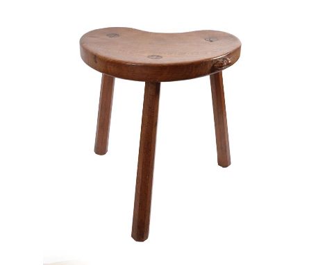 Workshop of Robert Mouseman Thompson (Kilburn): An English Oak Cow Stool, post 1955, the kidney shaped seat on three octagona