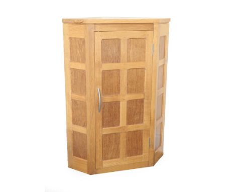 Workshop of Robert Mouseman Thompson (Kilburn): An English Oak Panelled Hanging Corner Cupboard, 2000, with contrasting fumed