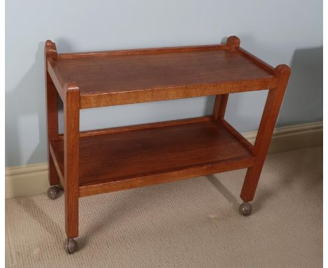 Workshop of Robert Mouseman Thompson (Kilburn): An English Oak Tea Trolley/Dinner Wagon, with two tiers both with raised side