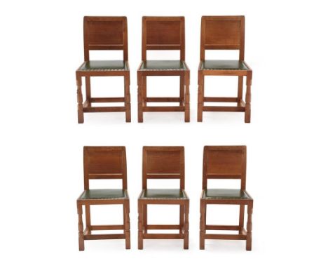 Workshop of Robert Mouseman Thompson (Kilburn): A Set of Six English Oak Panel Back Dining Chairs, nailed green hide upholste