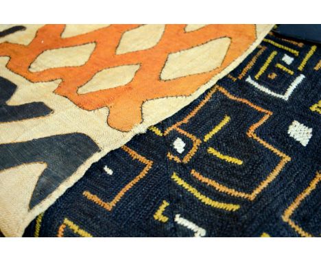 KUBA TEXTILES, two, one with black background with yellow, orange and white diamond pattern, other with cream background and 