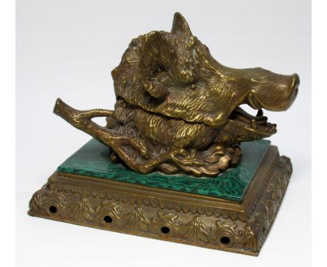 A VICTORIAN BRASS BOAR'S HEAD DESK TIDY INKWELL, SET ON A MALACHITE EFFECT CERAMIC TILE AND PIERCED BRASS PEDESTAL BASE, WITH