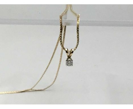 TEN CARAT GOLD SOLITAIRE PENDANT, set with a central diamond, on a ten carat gold chainQty: 2g