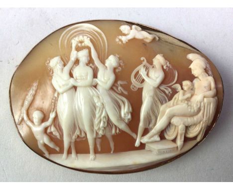 GOLD MOUNTED CAMEO BROOCH, LATE 19TH / EARLY 20TH CENTURY depicting the three graces and other figures, with safety chain, ma