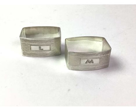 PAIR OF SILVER NAPKIN RINGS, with geometric engine turned decoration, initialled L and W60g gross